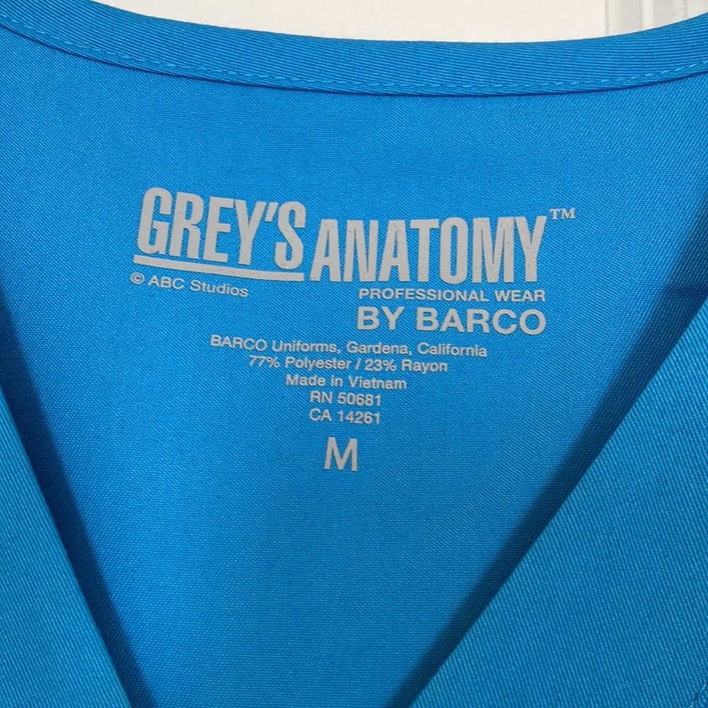 Grey’s Anatomy 2 Pocket Mock Wrap Top - Picture 2 of 5